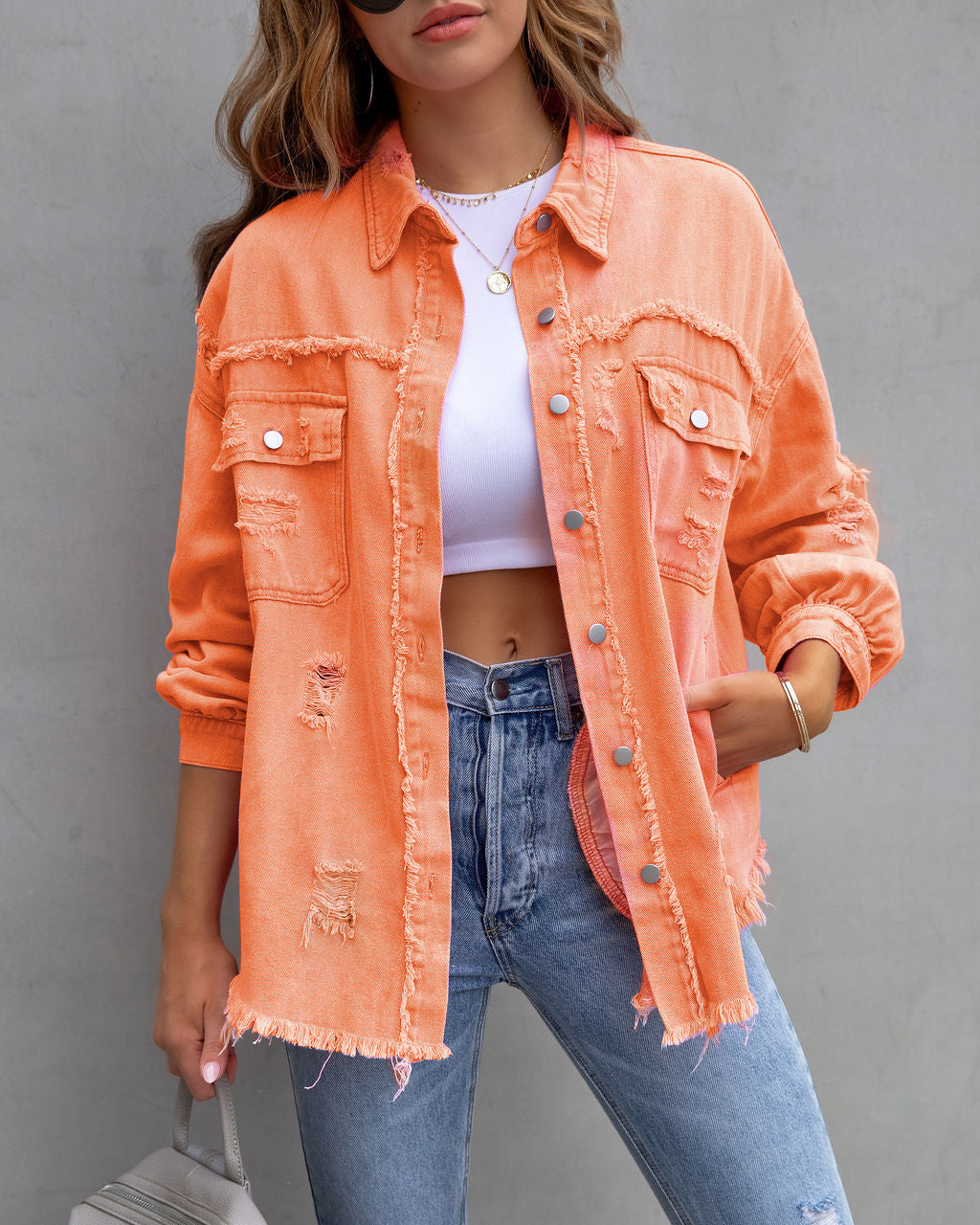 Ripped shirt jacket for women in pink, featuring a stylish design and frayed edges, perfect for casual wear.